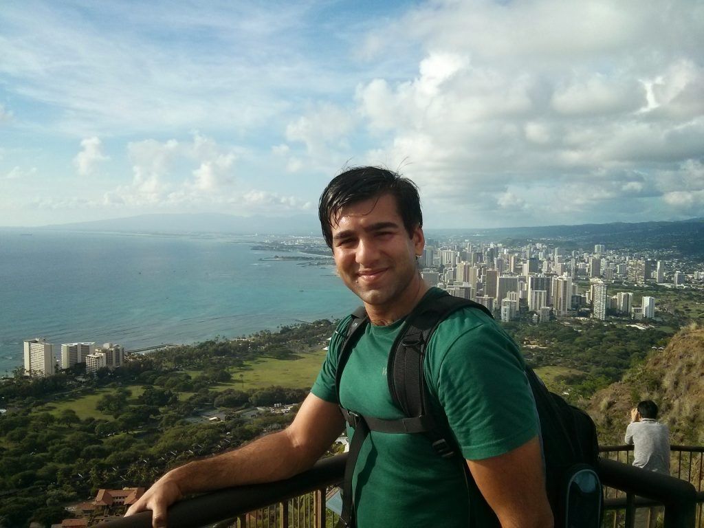 A panoramic view of a city with rolling hills in the background