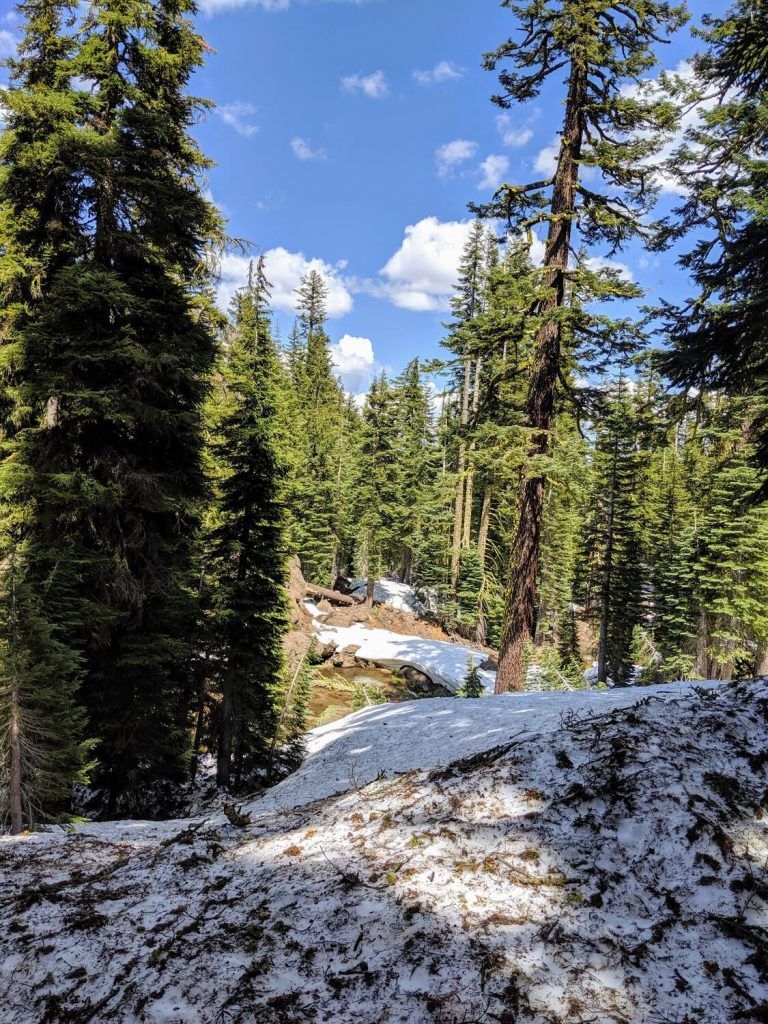 A scenic mountainous landscape with a snow-covered peak of the Brokeoff Mountain