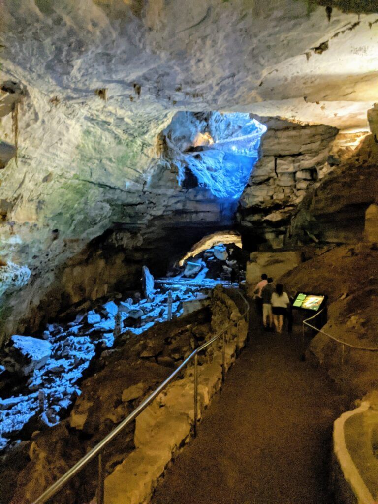 Carlsbad Caverns' intricate limestone formations, showcasing vast chambers with stalactites and stalagmites illuminated to highlight their grandeur.